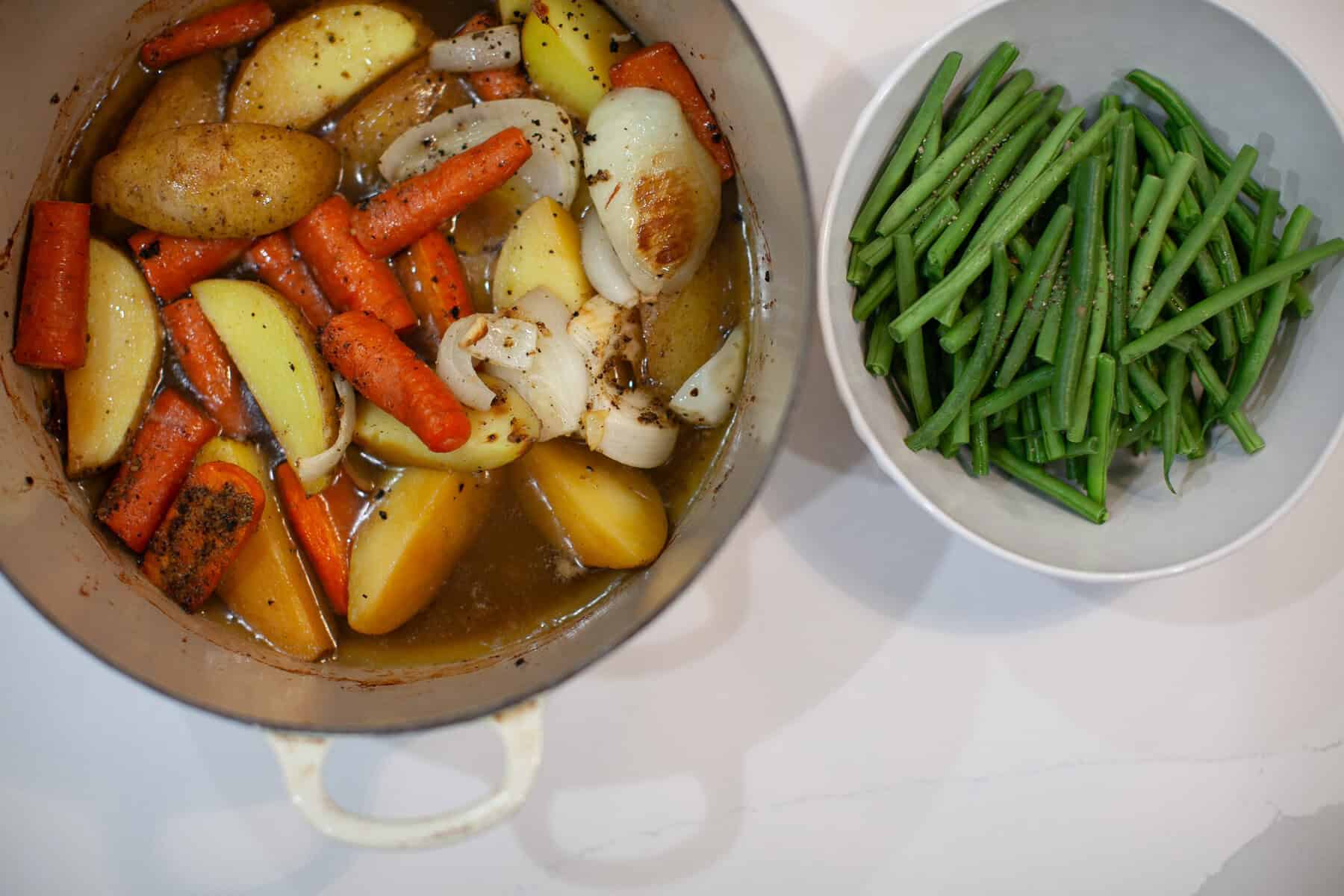 Oven-roasted chicken with vegetables and green beans on a sheet pan