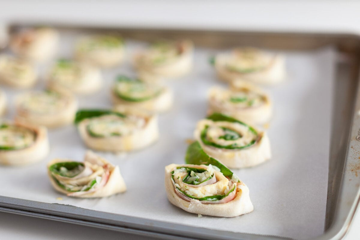 Turkey spinach pinwheels on baking sheet
